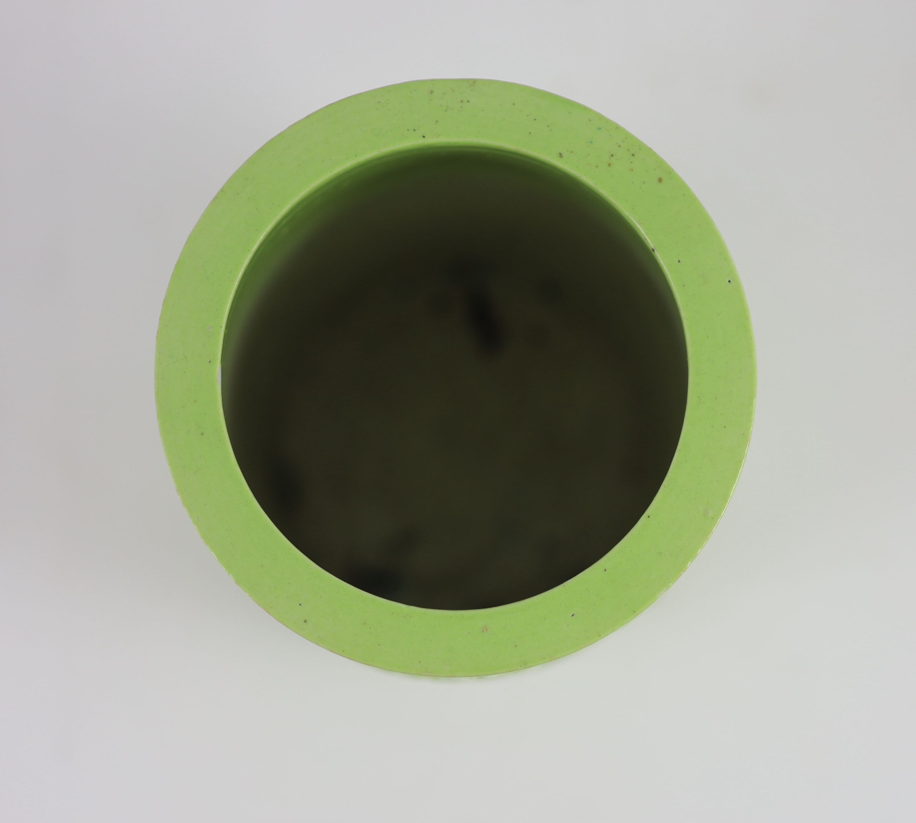 A Chinese lime green glazed brushpot, 19th century, 13.6 cm high, small splinter chip to inner rim